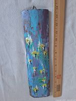 Full view of acrylic painting on curved wood panel beside ruler showing size