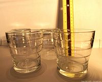 Four clear ribbed tumblers front view with ruler showing height ~3.5 in