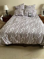 Bed with paisley duvet cover and shams