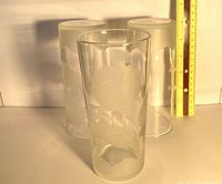 Front view of three tall etched floral glasses