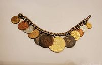 Full view of coin charm bracelet showing length and coin arrangement
