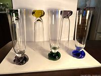 All six glass bud vases front view showing colored bases