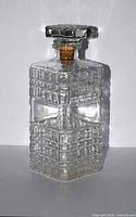 Rectangular block-cut glass decanter front view with stopper