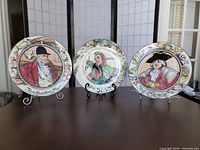 Front view of all three Royal Doulton T.C. series plates on stands