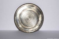 Front view of concentric-ribbed round silver-plated plate