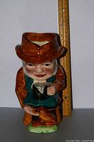 Front view of Gardener Toby jug with ruler for scale