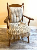 Wooden armchair with beige striped cushions