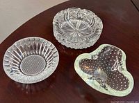 All three ashtrays displayed on tabletop