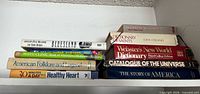 All ten books stacked on shelf