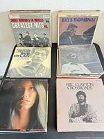 Stacks of LPs showing Smokey Robinson & The Miracles, Fats Domino, Bob Dylan, Clapton, Emmylou Harris