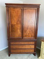 Front view of armoire showing doors and drawers