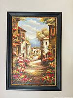 Full view of framed village landscape painting on wall