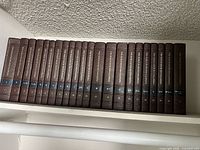 Full row of 22 World Book Encyclopedia volumes on shelf