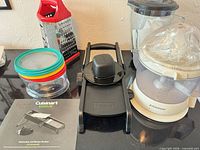 Group shot showing juicer, mandoline, shredding disc set, box grater and blender pitcher
