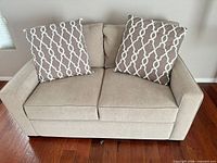 Front view of loveseat with two pillows