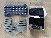 Overview of rectangular polka-dot pillow, U-shaped pillow, and boxed heated knee pads with adapter