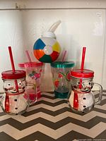 Group view of all five novelty cups with straws