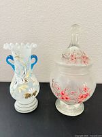 Front view of both glass pieces showing shape and painted designs