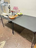 Both folding tables side by side showing tops and legs