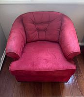 Front view showing button-tufted back, seat cushion, rolled arms