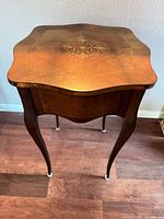 Full view of accent table showing shape, legs, and overall condition