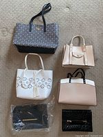 Group shot of all six handbags arranged on floor