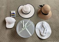 Overview of all hats, hat box and poncho
