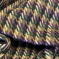 Close-up of fabric showing coffee, black, cream and purple check weave