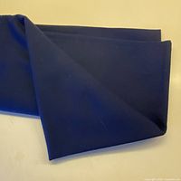 Folded navy blue wool fabric showing color and texture