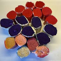 Top view of 20 wool yarn bundles showing colour assortment