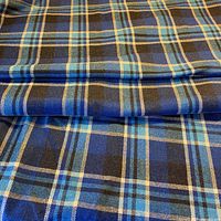Folded length of blue plaid wool blend fabric