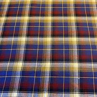Close-up of fabric showing blue, red, yellow plaid weave