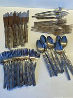 Full assortment of knives, forks, spoons and serving pieces laid out