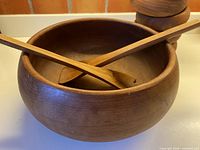 large teak bowl with two servers inside