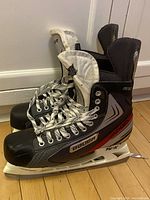 Full side view of both Bauer Vapor skates showing overall condition