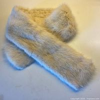 Full view of pale blond mink collar scarf laid flat