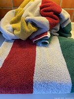 Two Hudson’s Bay striped cotton beach towels folded and draped