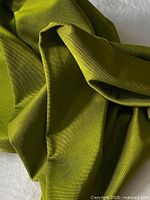 Close-up of apple green silk showing fine textured linear ribs