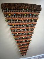 Full view of triangular wall hanging on wall