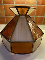 Full view of octagonal stained glass ceiling light showing amber and cream panels