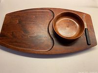 full view of cheeseboard, bowl, and knife
