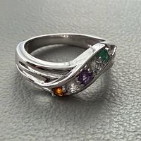 Angled view showing swirl design and gemstones