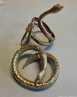 Both gold-tone snake bracelets showing overall shapes