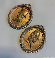 Both brass plaques front view showing portraits and shape