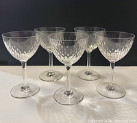 Group of five matching Baccarat crystal wine glasses showing overall design