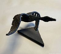 Overall view of cast iron flying goose sculpture on triangular base