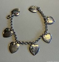 Overall view of bracelet showing chain and all seven heart charms
