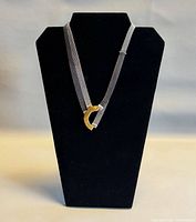 Necklace displayed on black bust showing overall form