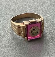 Full view of ring on side profile showing square stone and crest