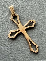 Front view of 14K yellow gold openwork cross pendant